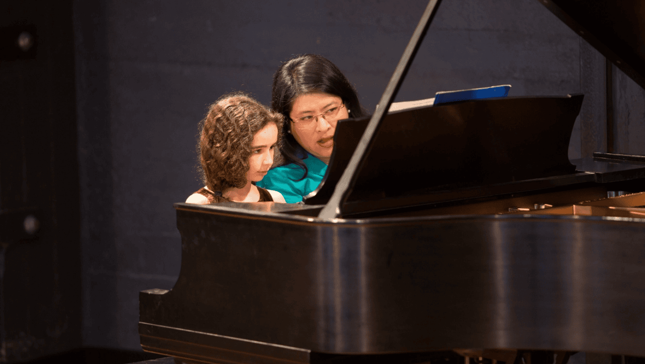 woman teaching piano at east bay center